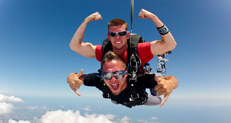 Two males skydiving together